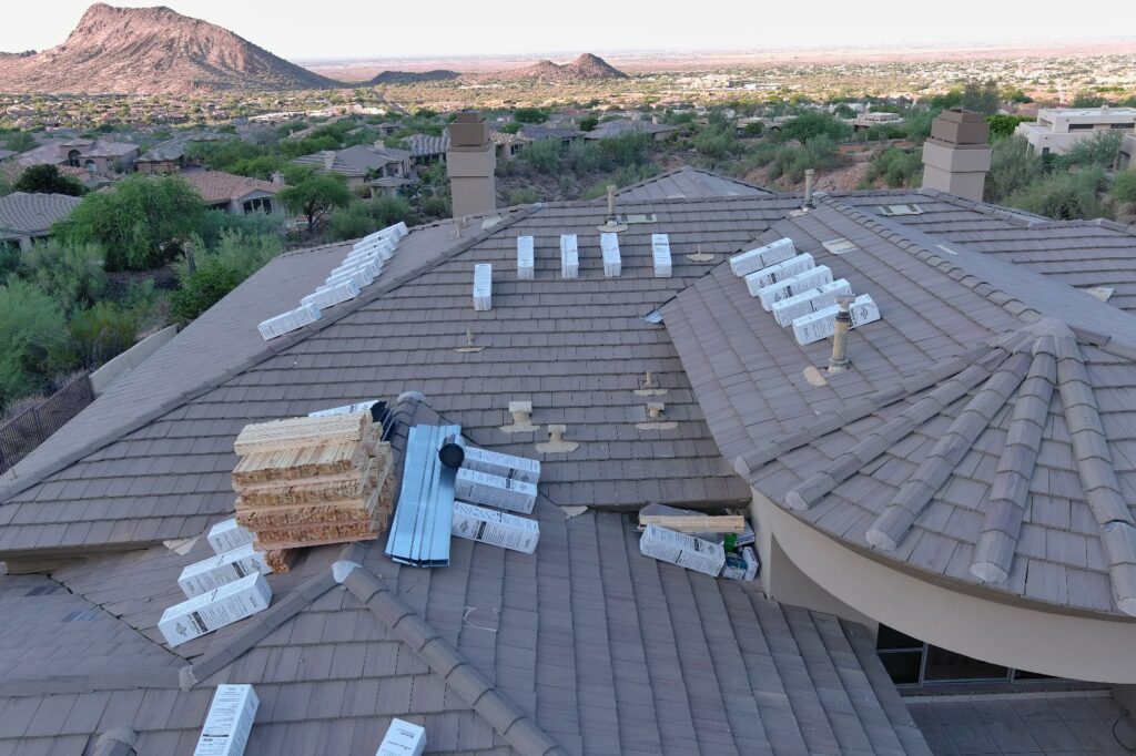 Aerial view of a tile roof during reset with tile staged for reinstall