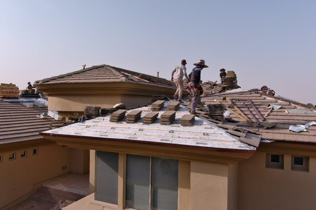 Roofers resetting tile on a home in Arizona
