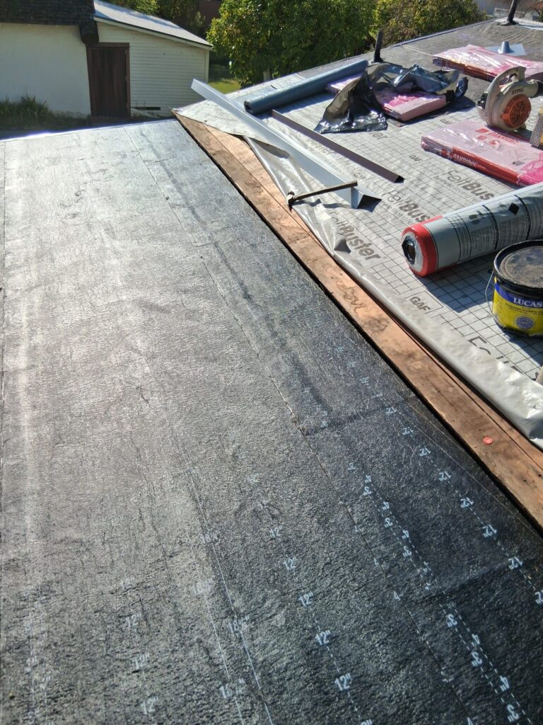 New underlayment installed on a roof deck before shingles