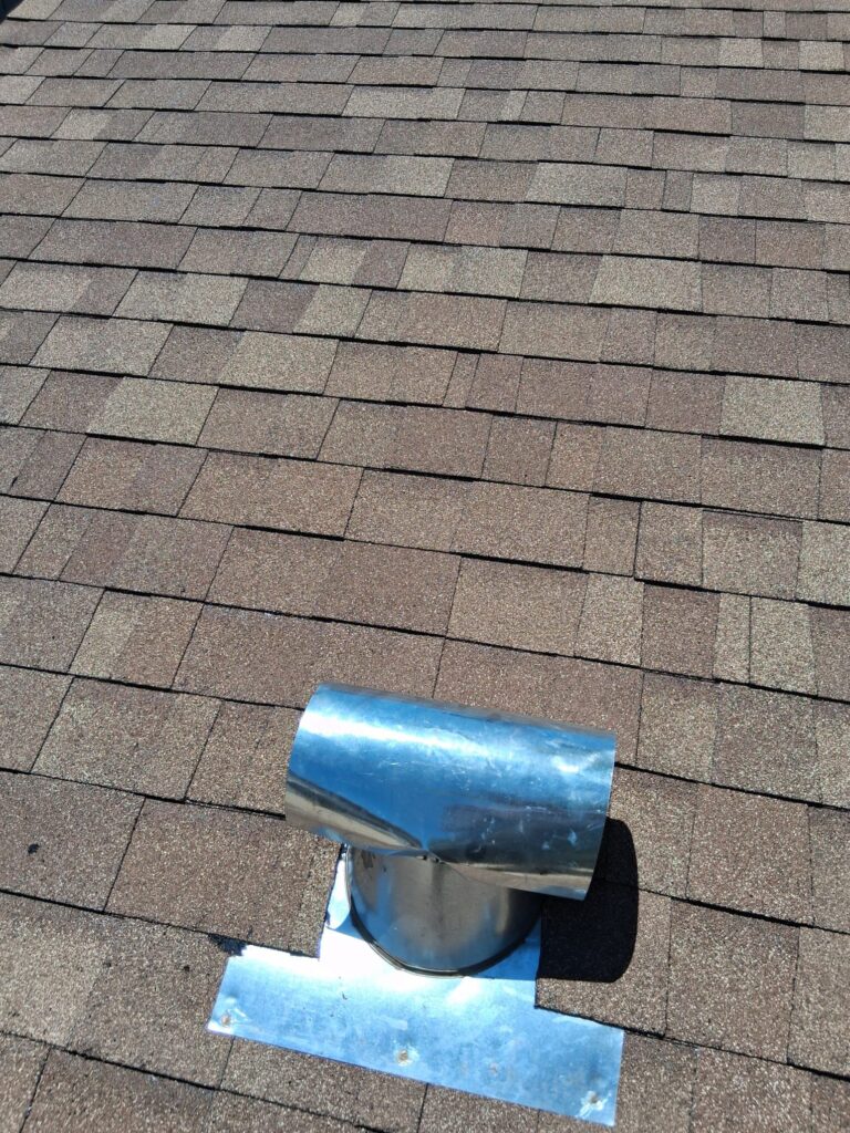New roof vent flashed on a shingle roof