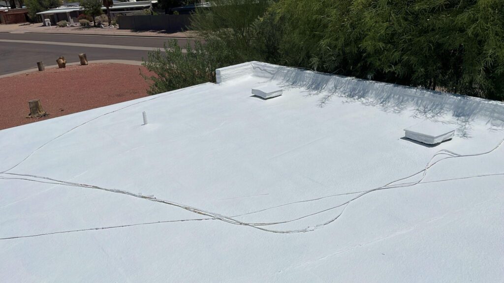 Finished white reflective coating on a flat roof, Tip Top Roofing Service