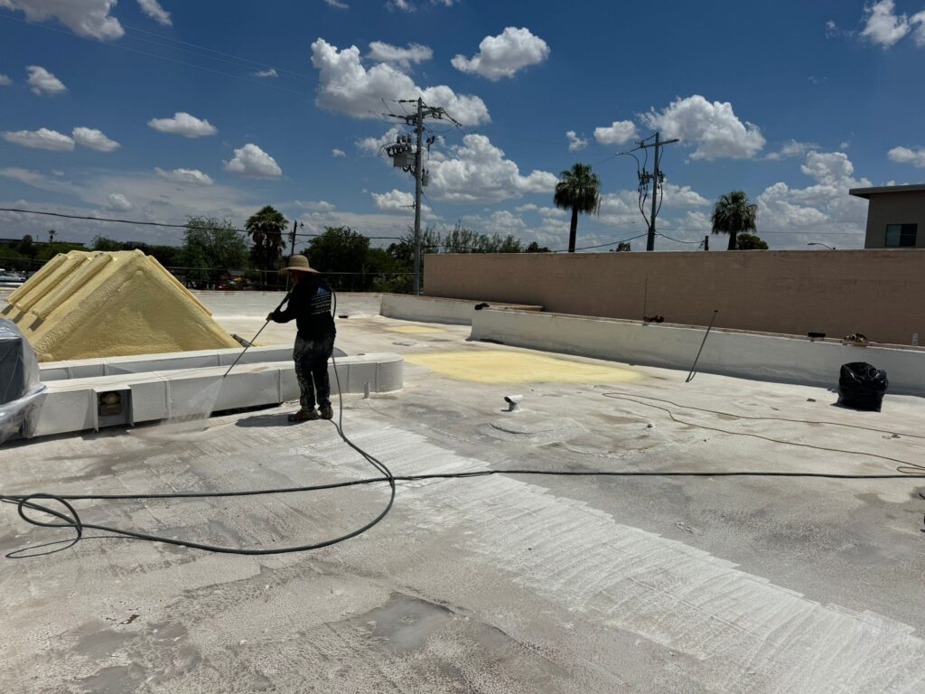 Crew spraying foam on a flat roof in the Phoenix metro