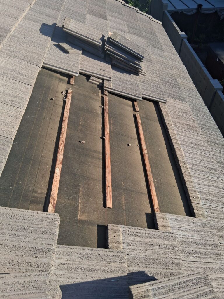 Roof section opened for repair with the wood deck exposed, Tip Top Roofing Service