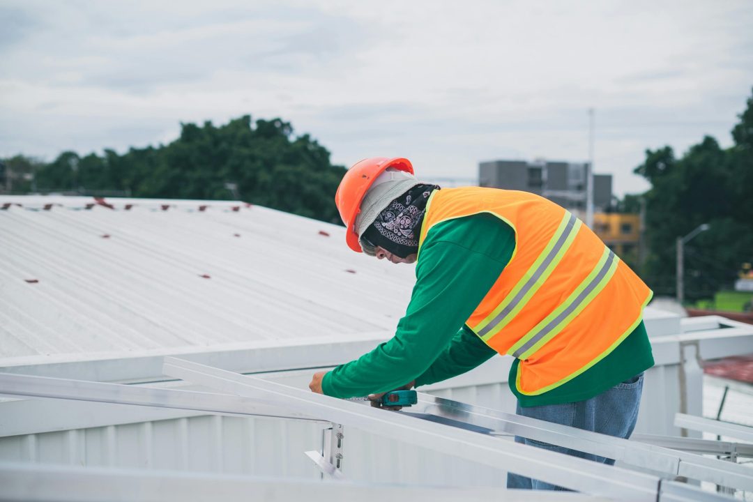 Roof repair technician working on a Scottsdale, AZ home